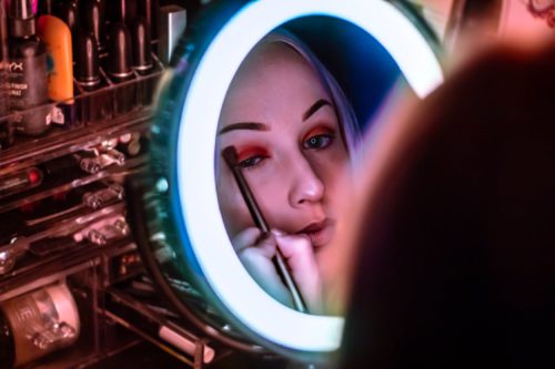 Makeup Application in Lighted Mirror