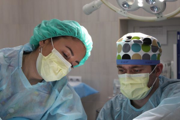 Doctors treating a patient with protective gear