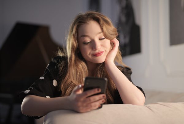 Girl Smiling at Smartphone